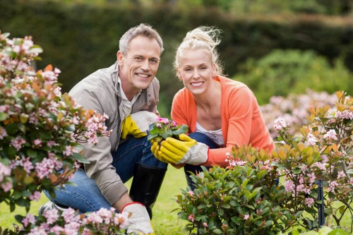 Trainer instructing gardening staff on equipment use