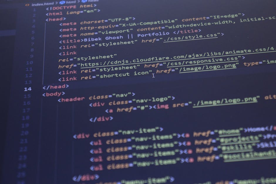 A photograph of a computer screen displaying HTML code in a development environment. The code includes tags such as <html>, <head>, <title>, and <body>, with syntax color-coded in blue, purple, red, a